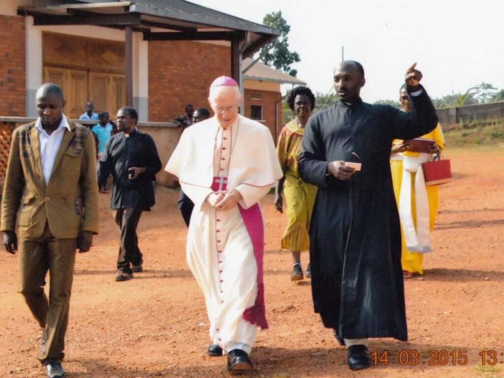 HE. + The Pope Nuncio Micheal B,  Fr Cloudius Ssegonja & Morris' visible and action of deepening the Church in volunerable communities including prisons, pointing at Christ.