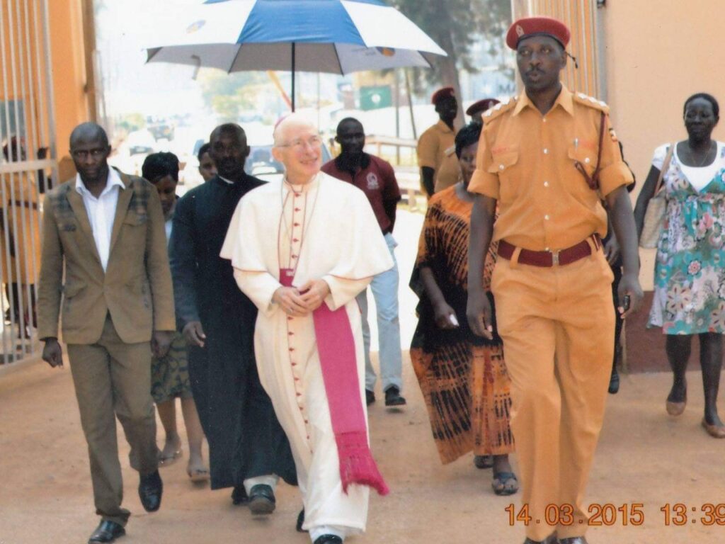 HE. + The Pope Nuncio Micheal B,  Fr Cloudius Ssegonja & Morris accompanied by the Uganda Police